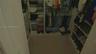 Walk-in closet featuring white built-in shelving, integrated dresser drawers, double-tier clothing rods, and vertical shoe storage units