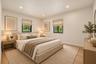 Neutral-toned room featuring recessed ceiling lighting, light wood-finish flooring, and black-framed windows