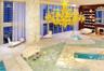 Floor-to-ceiling windows, wood-finish flooring, and recessed ceiling lighting