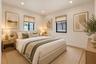 Neutral-toned interior featuring recessed lighting, two windows with black frames, and light wood-finish flooring