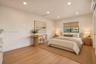 Room featuring wood-finish flooring, recessed lighting, and a window with a built-in window shade