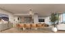 Open-concept kitchen and dining area featuring light-toned wood cabinetry, stone-finish countertops, three geometric pendant lights, and floor-to-ceil
