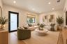 Neutral walls, wood-finish flooring, recessed lighting, and a black-framed exterior door with frosted glass
