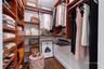Custom walk-in closet featuring floor-to-ceiling wooden cabinetry, built-in shelving