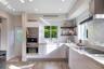 Kitchen featuring white cabinetry, wood-finish flooring, subway tile backsplash, stainless steel built-in appliances, and floating wood shelving