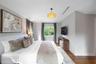 Bedroom featuring dark wood-finish flooring, a contemporary pendant light fixture, and recessed ceiling lighting
