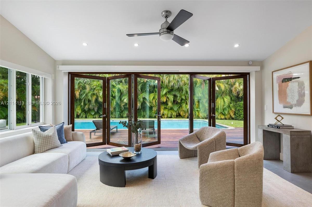 Multi-panel bi-folding glass doors, recessed lighting, ceiling fan
