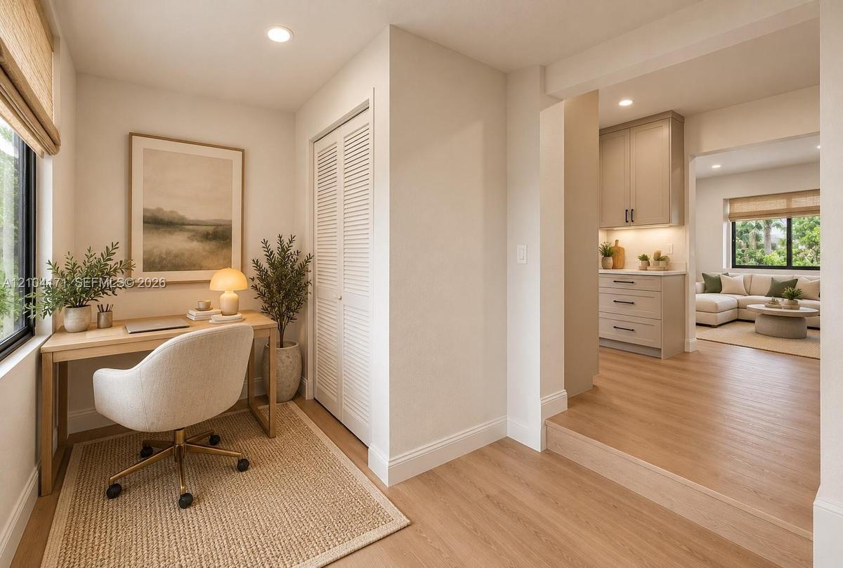 Wood-finish flooring, louvered-panel closet doors, recessed lighting, and built-in cabinetry featuring soft-close drawers and under-cabinet lighting
