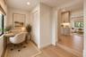 Wood-finish flooring, louvered-panel closet doors, recessed lighting, and built-in cabinetry featuring soft-close drawers and under-cabinet lighting
