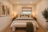 Neutral-toned room featuring recessed lighting, dual windows with black frames, and light-colored flooring
