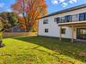 Spacious Backyard & Deck | Digitally Enhanced – Enjoy a generous, level backyard with beautiful seasonal foliage, and an elevated deck overlooking the