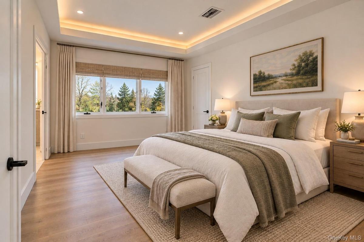 Primary Bedroom | Virtually Staged & Digitally Enhanced – Luxurious primary suite featuring beautiful white oak flooring, an elegant tray ceiling with