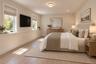 Lower Level Bedroom | Virtually Staged & Digitally Enhanced – Spacious, light-filled bedroom featuring beautiful white oak flooring, generous windows,