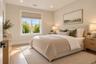 Bedroom 3 | Virtually Staged & Digitally Enhanced – Bright, inviting bedroom featuring white oak hardwood floors, recessed lighting, and a large windo
