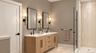 Primary Bathroom | Virtually Staged & Digitally Enhanced – Beautifully appointed with a spacious double vanity, elegant wood cabinetry, built-in medic
