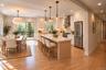 Kitchen & Breakfast Area | Virtually Staged & Digitally Enhanced – Beautiful open-concept kitchen featuring a spacious center island, custom cabinetry