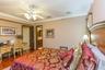 Interior space featuring crown molding, wood-finish flooring, and a ceiling fan with integrated light fixture