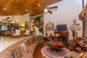 Vaulted ceiling with wood-plank finish, recessed lighting, ceiling fan, fireplace with ornate mantle, and staircase with metal railing
