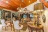 Vaulted wood-plank ceiling featuring recessed lighting and a central multi-arm chandelier