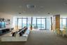 Expansive room featuring floor-to-ceiling windows, access to an outdoor balcony, built-in shelving, and recessed lighting