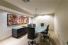 Recessed lighting with a suspended ceiling fixture, wall-mounted console cabinetry, and patterned wall covering