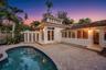 Exterior featuring a swimming pool, paved patio, stuccowork facade, cupola architectural element, and multi-light windows