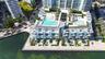 Rooftop amenities featuring multiple swimming pools, structured landscaping, and a waterfront promenade