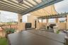 Rooftop terrace featuring a covered pergola with a retractable shade canopy, built-in outdoor kitchen, integrated lighting, and artificial turf floori