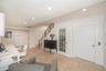 Tiled flooring, recessed lighting, staircase with metal railing, and glass-paneled interior door