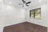 Room featuring wood-finish flooring, recessed lighting, and a multi-blade ceiling fan with integrated lighting