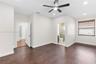 Interior space featuring wood-finish flooring, a multi-blade ceiling fan with integrated lighting, recessed lighting, and a window with horizontal bli