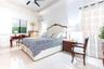 Tray ceiling, neutral tile flooring, and matte black ceiling fan