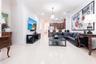 Polished large-format tile flooring, recessed ceiling lighting, crown molding, and an open kitchen featuring a tiered breakfast bar