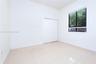 Neutral-toned ceramic tile flooring, dual-panel closet doors, and window featuring horizontal blinds