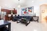 Open concept interior featuring tile flooring, recessed lighting, and a kitchen equipped with dark wood cabinetry and a raised breakfast bar