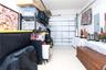 Enclosed garage space featuring a segmented overhead door, smooth-finish flooring, and a wall-mounted electrical panel