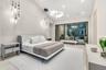 Vaulted ceilings featuring multi-tiered circular and drop-pendant lighting fixtures, floor-to-ceiling glass sliding doors, and light-toned hard-surfac