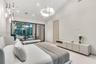 Vaulted ceilings featuring a circular crystal chandelier, recessed lighting, floor-to-ceiling black-framed windows, and built-in matte finish cabinetr