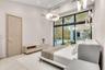 High-ceiling room featuring expansive floor-to-ceiling windows, modern tiered glass pendant lighting, a circular chandelier, and built-in wall cabinet