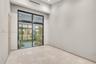 High-ceilinged room featuring large, floor-to-ceiling glass sliding doors, polished stone-finish flooring, recessed ceiling lighting, and a neutral co