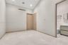 Vaulted ceilings with recessed lighting, stone-finish flooring, and minimalist wood-finish interior doors