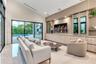Vaulted ceilings, expansive glass sliding doors, built-in floor-to-ceiling cabinetry, recessed lighting, and large-format tile flooring