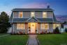 Welcome Home to 63 Mead St Hempstead! Two-story colonial exterior featuring horizontal siding, a gabled portico, brick entry steps, multi-pane windows