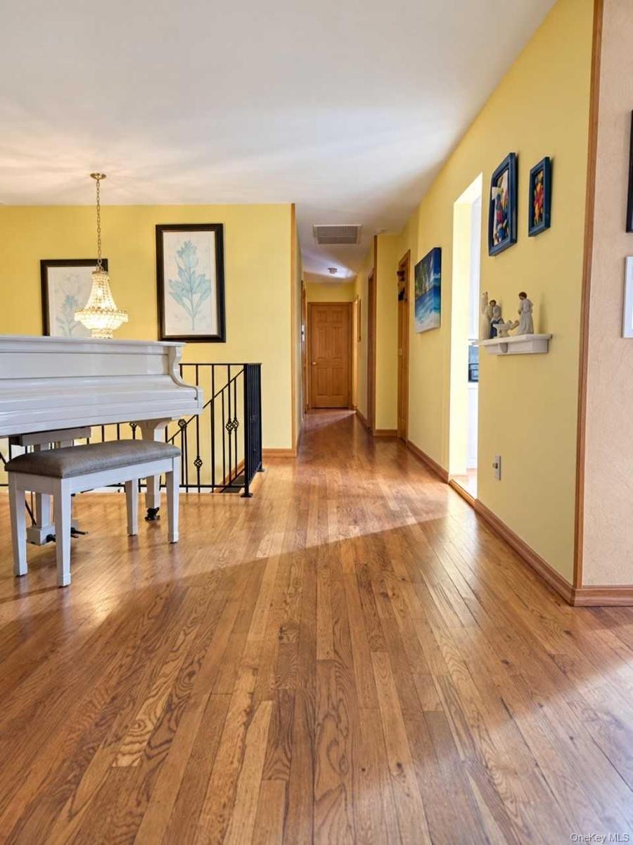 Upper-level top of the stairs hallway to bedroom and living room view