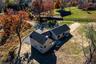 Aerial View of Home with Surrounding Lawns & Trees