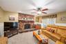 Brick Fireplace featuring a stone hearth with slider to enclosed 4 Season Room