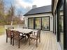 Living Room Wall of Glass Doors Open to Deck for Entertaining