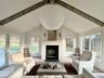 LR Walls of Windows & Views with a Wood Burning Fireplace
