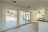 Landing Opens to a Wall of Sliding Glass Doors to Back Deck