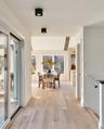 Open Hallway Leads to Great Room & Glass Doors to Deck